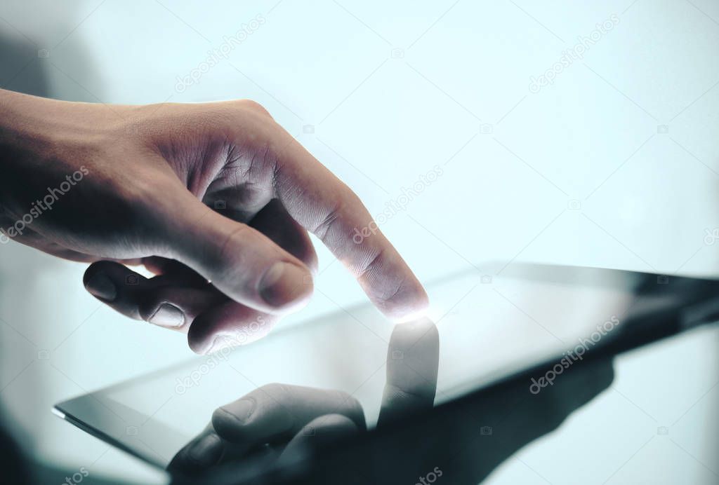 Hand using digital tablet.