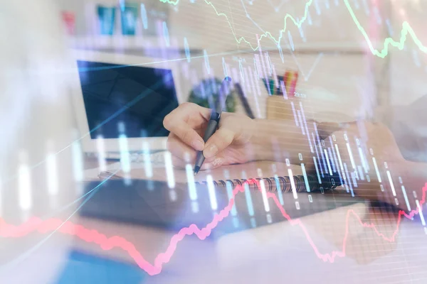 Financial graph displayed on womans hand taking notes background. Concept of research. Double exposure