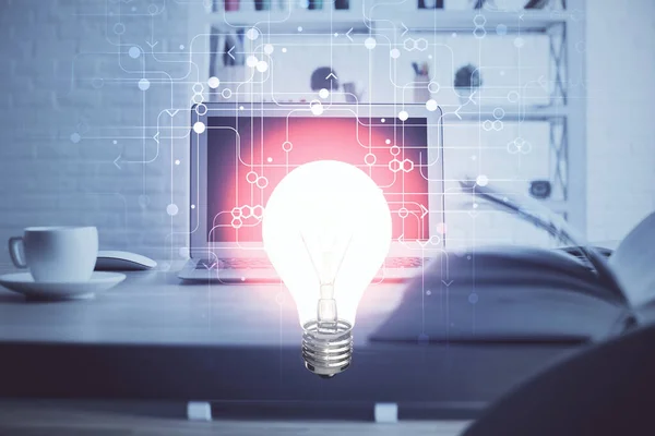 電球アイコンのホログラムを持つオフィスのデスクトップ上のコンピュータ。多重露光。アイデアの概念. — ストック写真