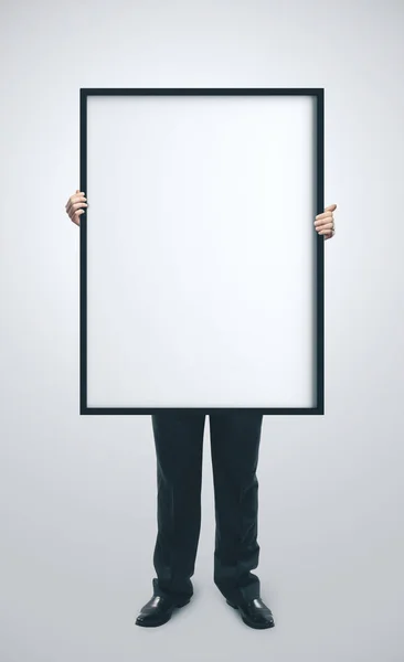 Businessman holding blank poster — Stock Photo, Image