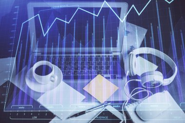Finansal pazar grafiği hologramı ve kişisel bilgisayar arka planda. Çifte maruziyet. Önx kavramı.