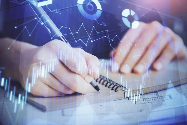 Forex graph on hand taking notes background. Concept of research. Double exposure