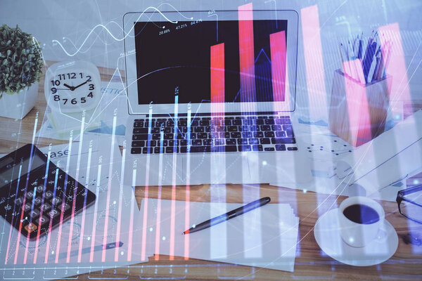 Stock market graph on background with desk and personal computer. Multi exposure. Concept of financial analysis.