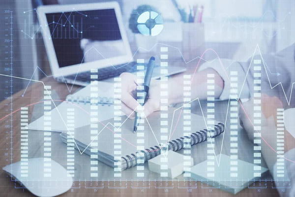 Financial charts displayed on womans hand taking notes background. Concept of research. Double exposure — Stock Photo, Image