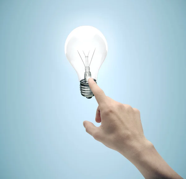 Hand pushing light bulb — Stock Photo, Image