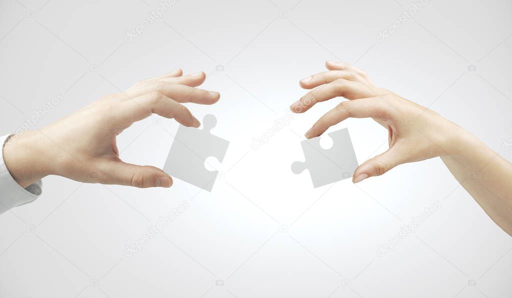 Hands putting puzzle pieces together