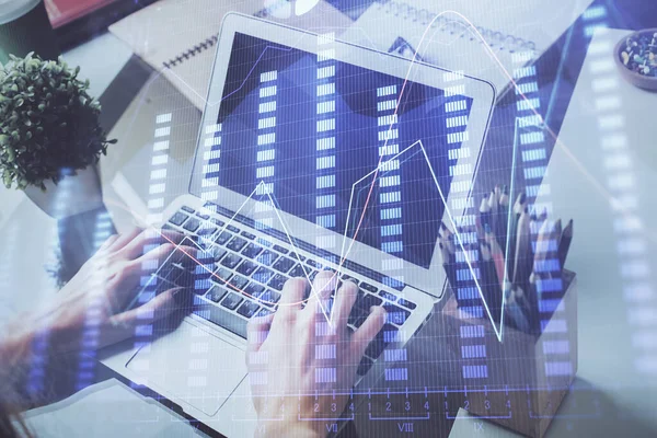 Double exposure of stock graph with businessman typing on computer in office on background. Concept of hard work. — Stock Photo, Image