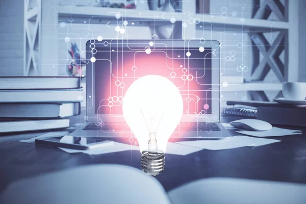 Computer on desktop in office with bulb icon hologram. Multi exposure. Concept of idea. — Stock Photo, Image
