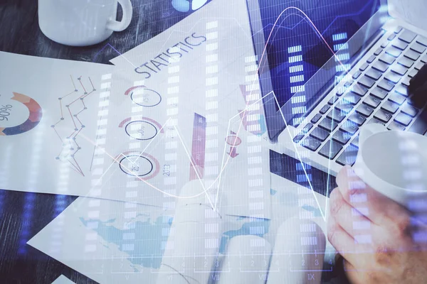 Doble exposición del gráfico de stock con hombre de negocios escribiendo en la computadora en la oficina en segundo plano. Concepto de trabajo duro . —  Fotos de Stock