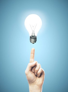 Hand points to lamp on a blue background.