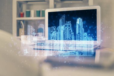 Ofisteki masaüstü bilgisayar geçmişi ve büyük kasaba binaları hologram çizimi. Çifte maruziyet. Akıllı şehir konsepti.