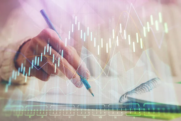 Financial forex graph displayed on hands taking notes background. Concept of research. Double exposure — Stock Photo, Image