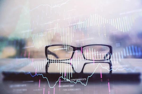 Financial graph hologram with glasses on the table background. Concept of business. Double exposure.