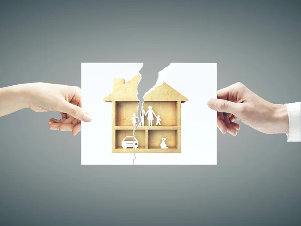 Hands hold torn sheet of paper with  family — Stock Photo, Image