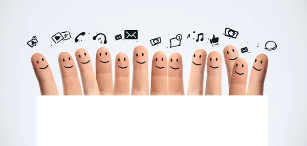 Happy group of finger smileys with social media icons — Stock Photo, Image