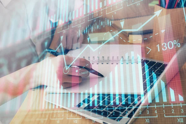 Financial charts displayed on womans hand taking notes background. Concept of research. Double exposure — Stock Photo, Image