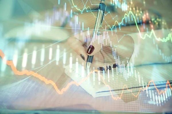 Multi exposure of hands making notes with forex chart huds. Stock market concept.