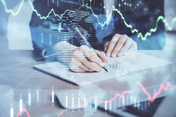 Forex graph on hand taking notes background. Concept of research. Multi exposure