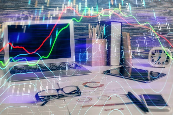 Double exposure of graph and financial info and work space with computer background. Concept of international online trading.