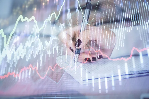 Multi exposure of hands making notes with forex chart huds. Stock market concept.