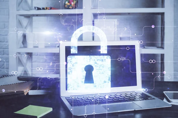 Double exposure of desktop with computer and lock icon hologram. Concept of data safety.