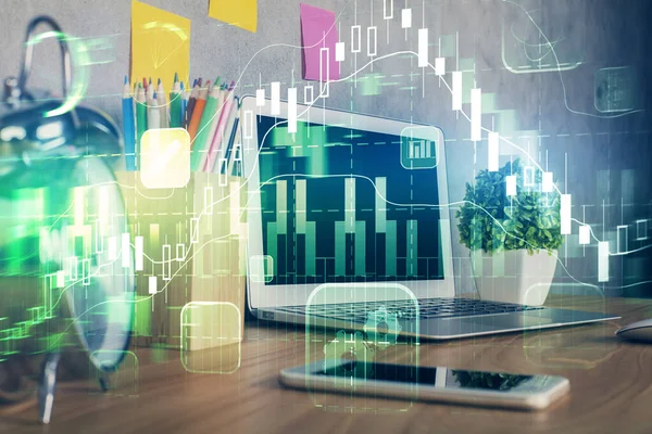 Financial graph colorful drawing and table with computer on background. Multi exposure. Concept of international markets.