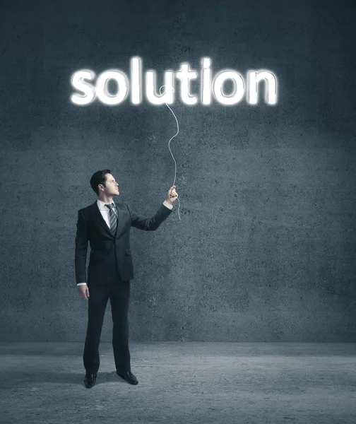 Businessman Holding Glowing Solution Symbol Concrete Room Success Startup Concept — Stock Photo, Image