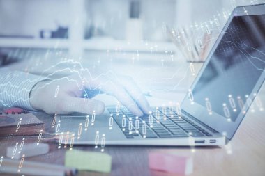 Arka planda dizüstü bilgisayar üzerinde çalışan adam ile borsa grafiği çift pozlama. Finansal analiz kavramı.