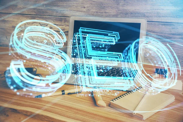 Dubbel exponering av bord med dator och seo ritning hologram. Sökoptimeringskoncept. — Stockfoto