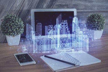 Ofisteki masaüstü bilgisayar geçmişi ve büyük kasaba binaları hologram çizimi. Çifte maruziyet. Akıllı şehir konsepti.