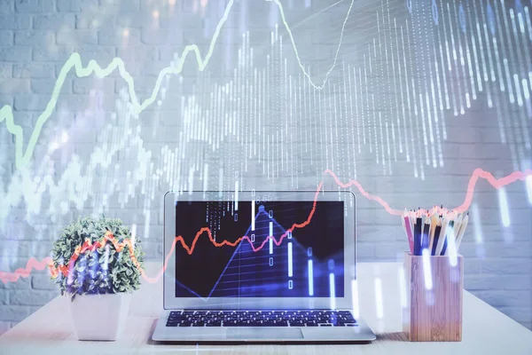 Financial graph colorful drawing and table with computer on background. Multi exposure. Concept of international markets.