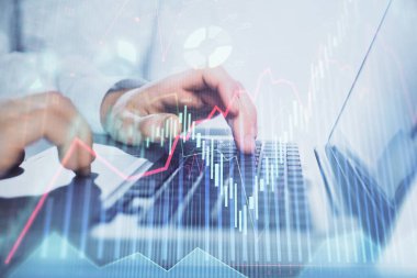 Arka planda bilgisayarda çalışan bir adamla piyasa grafiği iki katına çıktı. Mali analiz kavramı.