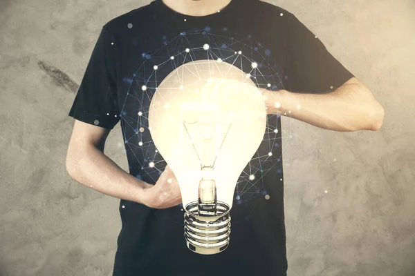 Double exposure of mans hands holding and using a digital device and bulb hologram drawing. Idea concept. — Stock Photo, Image
