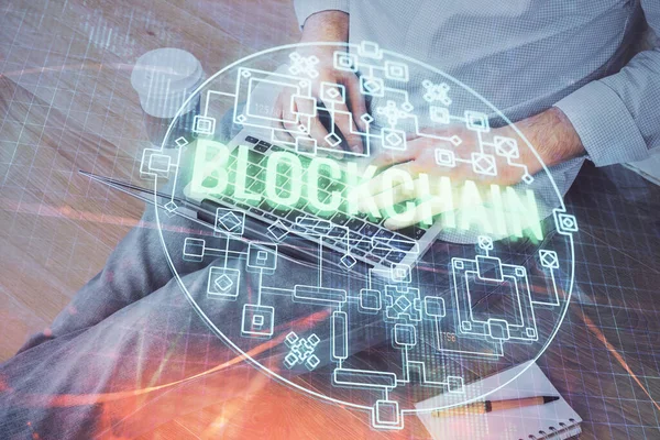 Crypto moneda tema holograma con el hombre de negocios que trabaja en la computadora en segundo plano. Concepto de blockchain. Doble exposición . — Foto de Stock