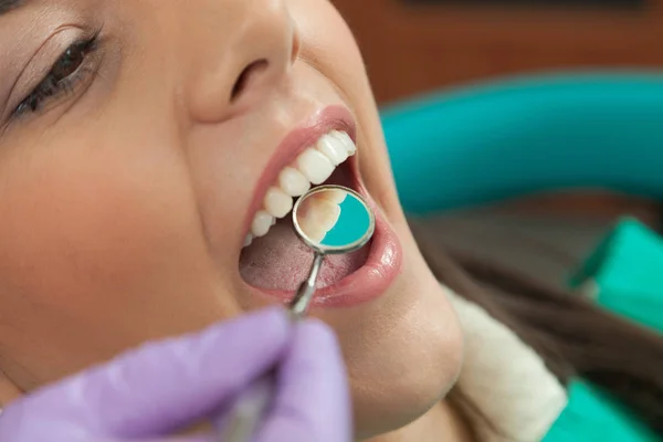 Dentist identifying cavities in mouth of patient — Stock Photo, Image