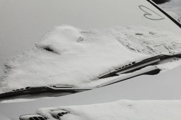 Coche aparcado cubierto con la primera nieve en invierno — Foto de Stock