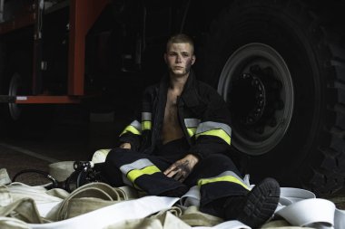 September 03, 2019, Ukraine Lviv city, young pretty and sexy firefighter sits by fire truck