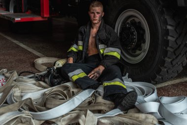 September 03, 2019, Ukraine Lviv city, young pretty and sexy firefighter sits by fire truck