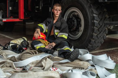 September 03, 2019, Ukraine Lviv city, young pretty and sexy firefighter sits by fire truck