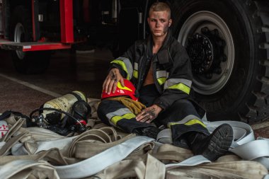 September 03, 2019, Ukraine Lviv city, young pretty and sexy firefighter sits by fire truck