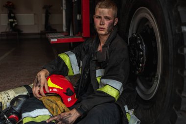 September 03, 2019, Ukraine Lviv city, young pretty and sexy firefighter sits by fire truck