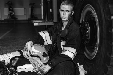 September 03, 2019, Ukraine Lviv city, young pretty and sexy firefighter sits by fire truck