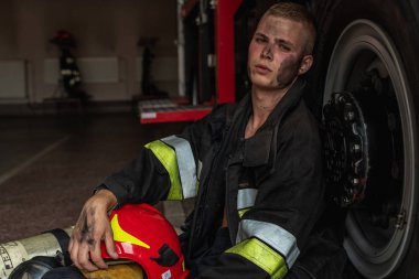 September 03, 2019, Ukraine Lviv city, young pretty and sexy firefighter sits by fire truck