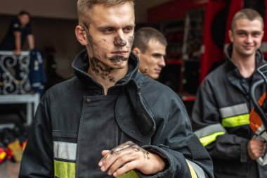 September 03, 2019, Ukraine Lviv city, young pretty and sexy firefighter sits by fire truck