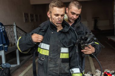 September 03, 2019, Ukraine Lviv city, young pretty and sexy firefighter sits by fire truck