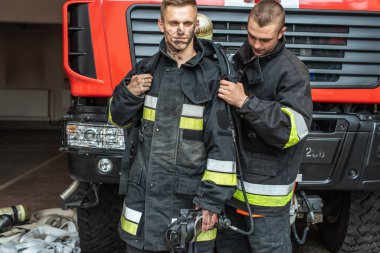 September 03, 2019, Ukraine Lviv city, young pretty and sexy firefighter sits by fire truck