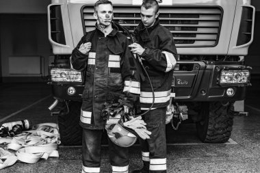 September 03, 2019, Ukraine Lviv city, young pretty and sexy firefighter sits by fire truck