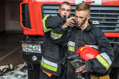 September 03, 2019, Ukraine Lviv city, young pretty and sexy firefighter sits by fire truck