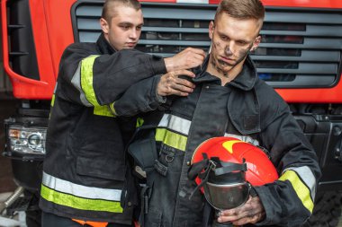 September 03, 2019, Ukraine Lviv city, young pretty and sexy firefighter sits by fire truck