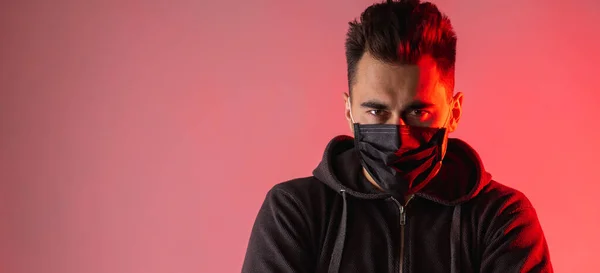 virologist shows a man in a black mask the result of testing for virus, danger, virus, concern, experience, protection, on a red background